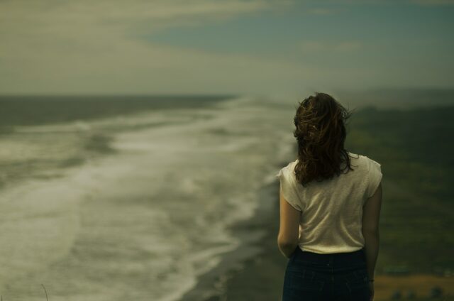 woman on beach dark and depressing