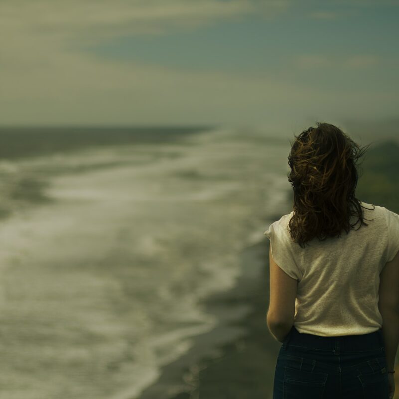 woman on beach dark and depressing