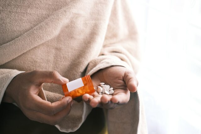addiction pills in hand