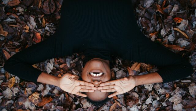 smile gums on autumn leaves