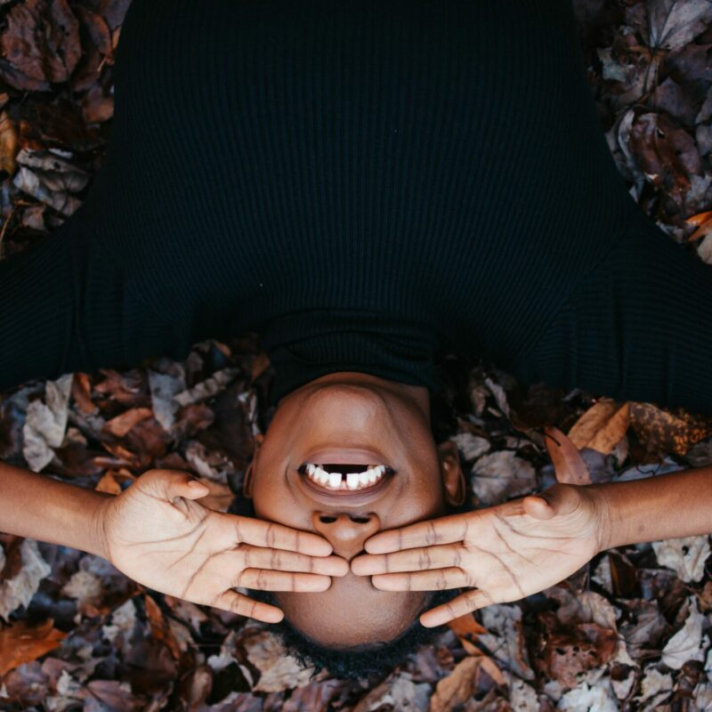 smile gums on autumn leaves