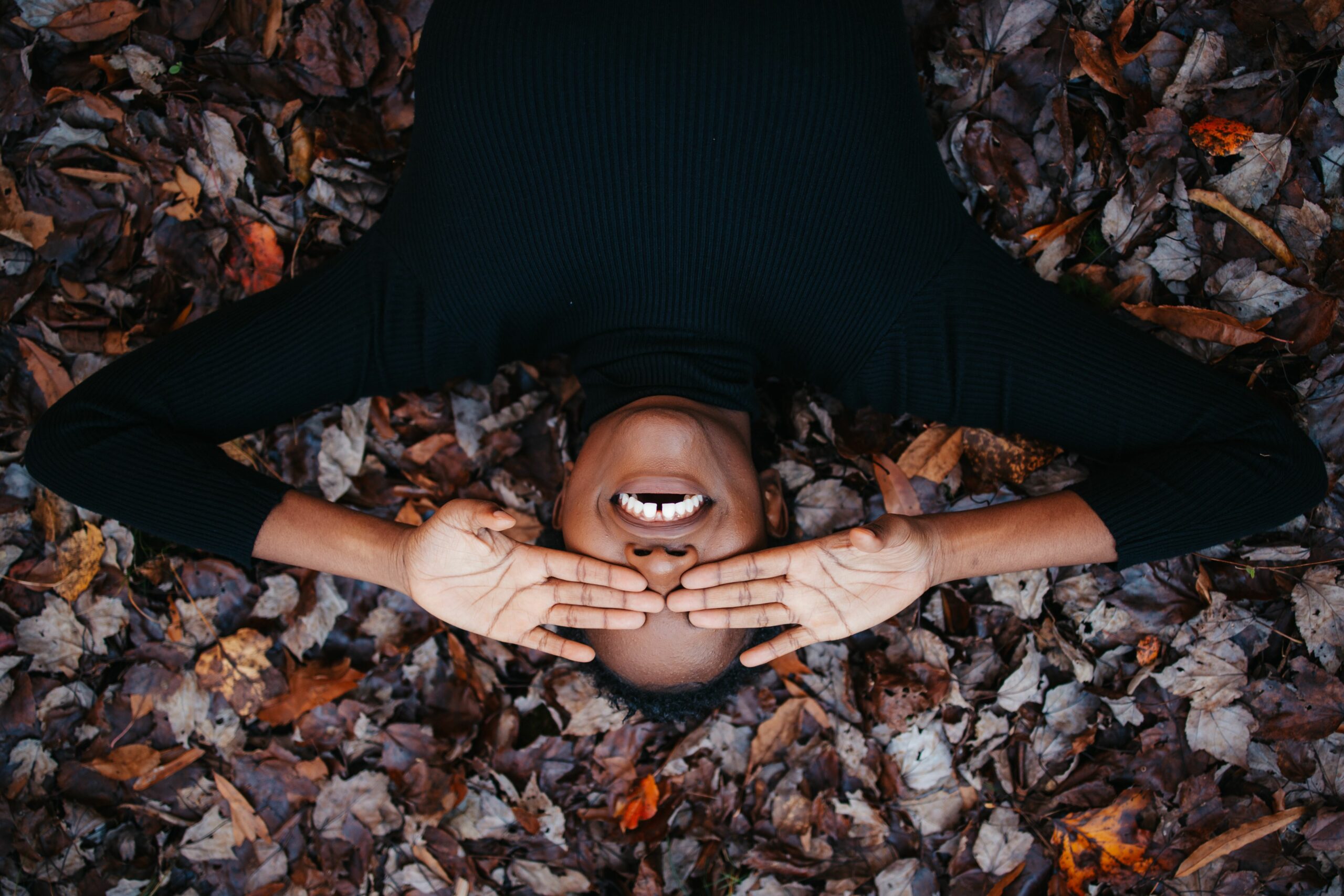 smile gums on autumn leaves