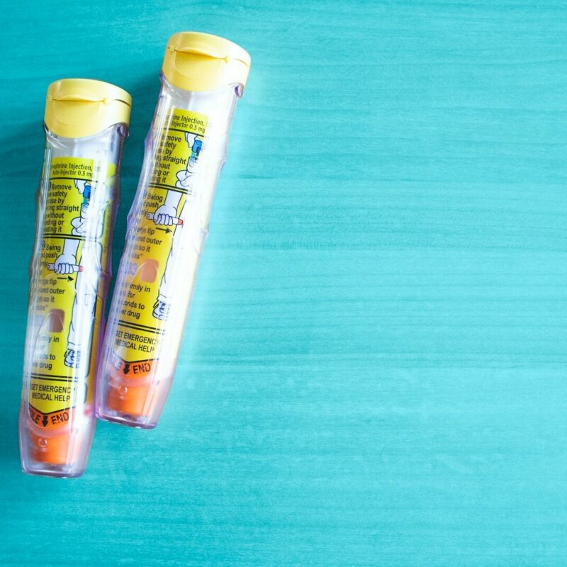 EpiPen on blue background