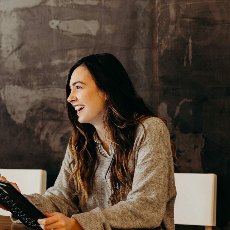someone laughing using a laptop